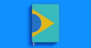 Caderno com a bandeira do Brasil sobre fundo azul
