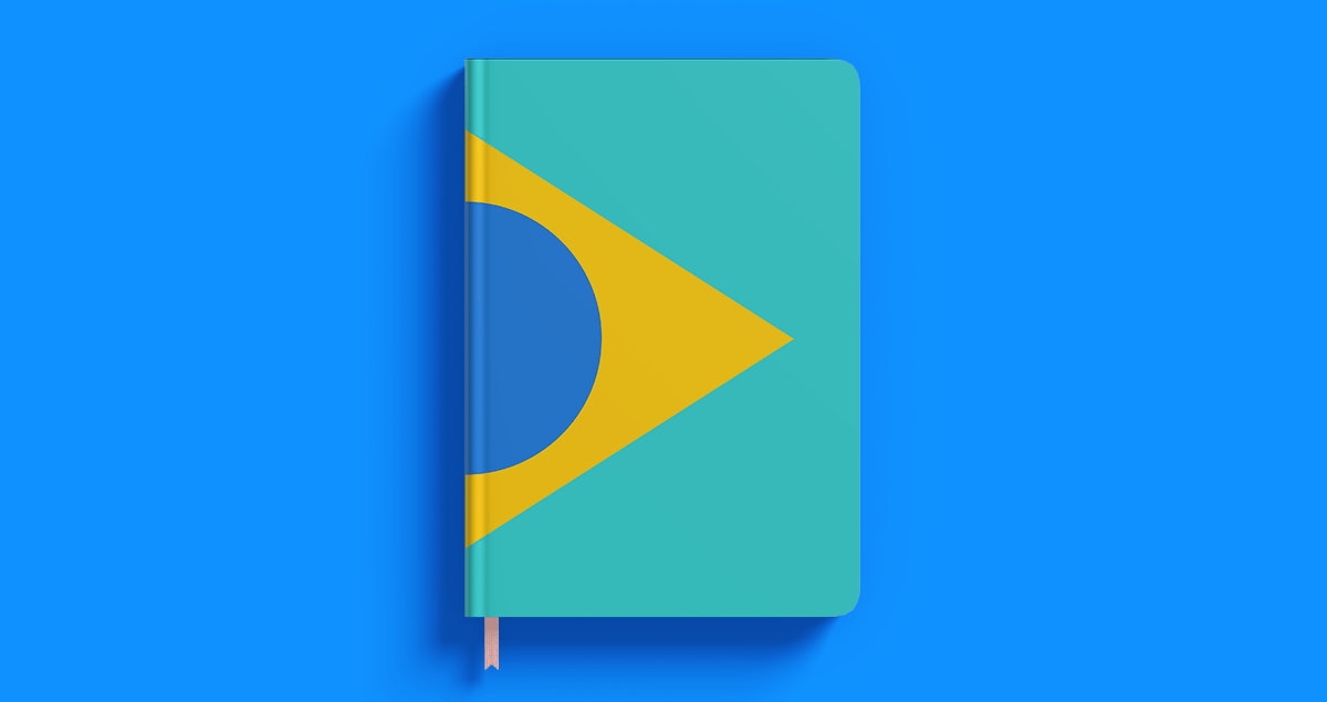 Caderno com a bandeira do Brasil sobre fundo azul